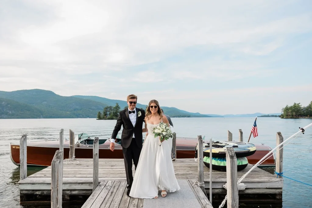 bride and groom wearing sunglasses on dock at Lake George, NY